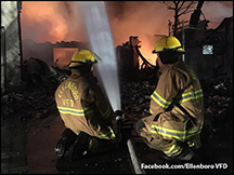 Ellenboro VFD fireman spraying water into the masssive IEI fire.